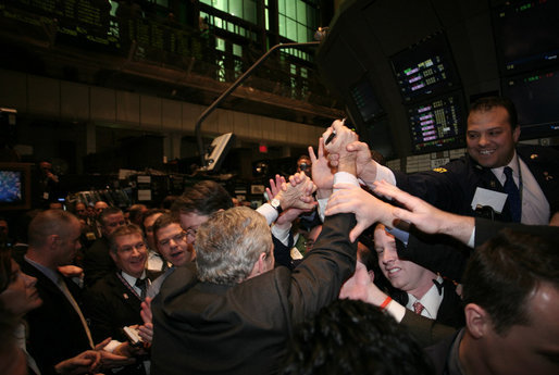 President George W. Bush is surrounded by traders on the floor of the New York Stock Exchange Wednesday, Jan. 31, 2007, during a surprise stop while on Wall Street to deliver remarks on the economy at Federal Hall. White House photo by Paul Morse