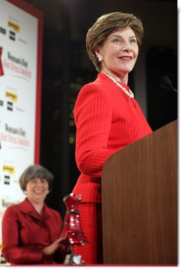 Mrs. Laura Bush accepts the Woman's Day Magazine Red Dress Award in New York, NY for her leadership in raising awareness of women's heart disease, February 1, 2007, as Jane Chestnutt, Editor in Chief of Woman's Day, looks on. White House photo by Shealah Craighead