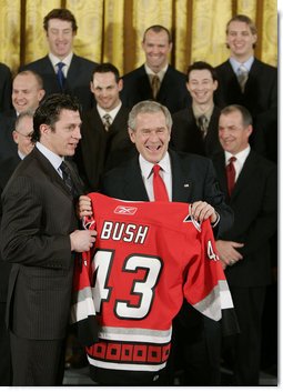 President George W. Bush receives a personalized team sweater from the Carolina Hurricane's team captain, Rod Brind'Amour, as the team was honored Friday, Feb. 2, 2007, at the White House for winning the 2006 Stanley Cup. White House photo by Paul Morse