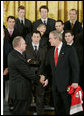 President George W. Bush shakes hands with Jim Rutherford, president and general manager of the Carolina Hurricanes hockey team, winners of the 2006 Stanley Cup, as Rutherford presents President Bush with a championship ring Friday, Feb. 2, 2007 in the East Room at the White House. White House photo by Paul Morse