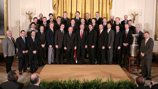 President George W. Bush poses for a photo Friday, Feb. 2, 2007, with the Carolina Hurricanes, winners of the 2006 Stanley Cup, in the East Room of the White House. White House photo by Paul Morse