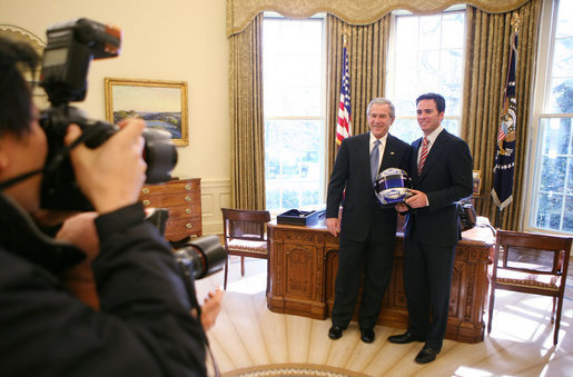 President George W. Bush and 2006 NASCAR Nextel Cup Champion Jimmie Johnson meet in the Oval Office, joined by members of the media, Monday, Feb. 5, 2007, in honor of Johnson's championship NASCAR season. White House photo by Eric Draper