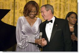 President George W. Bush thanks Yolanda Adams after her performance at a dinner in honor of the Ford’s Theatre Abraham Lincoln Bicentennial Celebration Sunday, Feb. 11, 2007.  White House photo by Paul Morse