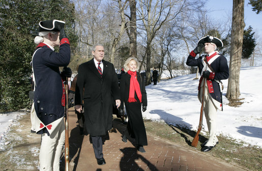 President George W. Bush is escorted by Gay Hart Gaines, Regent of the Mount Vernon Ladies Association, as President Bush and Mrs. Laura Bush arrive Monday, Feb. 19, 2007 to the Mount Vernon Estate in Mount Vernon, Va., to lay a wreath at the tomb of President George Washington in honor of Washington’s 275th birthday. White House photo by Eric Draper