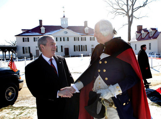 President George W. Bush shakes hands with General George Washington, played by actor Dean Malissa, following President Bush’s address at the Mount Vernon Estate, Monday, Feb. 19, 2007 in Mount Vernon, Va., honoring Washington’s 275th birthday. White House photo by Eric Draper