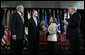 President George W. Bush stands with Director of National Intelligence J. Michael “Mike” McConnell during his ceremonial swearing-in Tuesday, Feb. 20, 2007 at Bolling Air Force Base in Washington, D.C., taking his oath from White House Chief of Staff Josh Bolten , as McConnell’s wife, Terry, holds the Bible. White House photo by Paul Morse