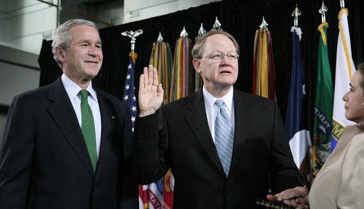 President George W. Bush attends the ceremonial swearing-in of Director of National Intelligence J. Michael “Mike” McConnell, Tuesday, Feb. 20, 2007 at Bolling Air Force Base in Washington, D.C., taking his oath of office as McConnell’s wife, Terry, holds the Bible. White House photo by Paul Morse