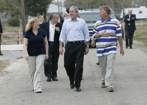 President George W. Bush walks with Cheryl and Ernie Woodard through their Long Beach, Miss., neighborhood Thursday, March 1, 2007, during the President’s tour of the neighborhood where some homes, including the Woodward's, damaged by Hurricane Katrina have been rebuilt with Gulf Coast grant money. White House photo by Eric Draper