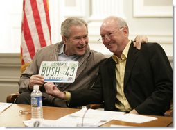President George W. Bush is presented with a license plate with his name and the number 43 from Biloxi, Miss., Mayor A. J. Holloway, during a meeting Thursday, March 1, 2007 in Biloxi, on the recovery and reconstruction efforts underway in the region devastated by Hurricane Katrina.  White House photo by Eric Draper