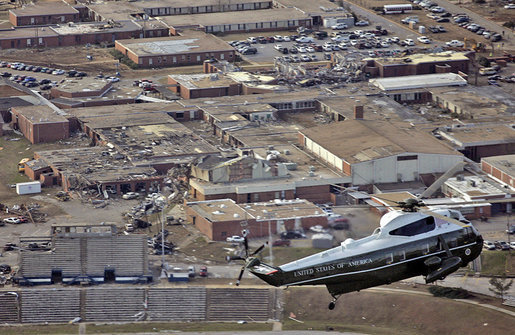 President George W. Bush surveys tornado damage to Enterprise High School from Marine One in Enterprise, Ala., Saturday, March 3, 2007. The President visited people affected by storms in Americus, Ga., and Enterprise, Ala. "We can never replace lives, and we can't heal hearts, except through prayer. And I know -- I want the students to know, and the families to know that there's a lot of people praying for them," said President Bush after walking through Enterprise High School. White House photo by Paul Morse
