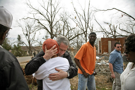 President George W. Bush comforts residents whose neighborhood was hit by a tornado in Americus, Ga., Saturday, March 3, 2007. "You can never heal a heart, but you can provide comfort, knowing that the federal government will provide help for those whose houses were destroyed, or automobiles were destroyed," said President Bush during his trip to Enterprise, Ala., and Americus, Ga. White House photo by Paul Morse