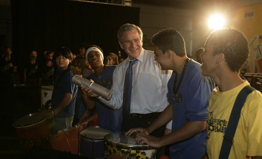 President George W. Bush joins the festivities Friday, March 9, 2007, as he plays percussion with a group of musicians after a community roundtable at Meninos do Morumbi in Sao Paulo. White House photo by Eric Draper