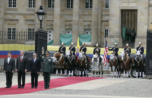 President George W. Bush stands at attention during an arrival ceremony with Colombian President Alvaro Uribe at Casa de Narino in Bogotá, Colombia, Sunday, March 11, 2007. White House photo by Eric Draper