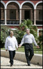 President George W. Bush and Mexico's President Felipe Calderon walk along a path Tuesday, March 13, 2007, en route to a meeting at the Hacienda Temozon in Temozon Sur, Mexico. The visit to the area marked the final leg of the President's five-country Latin American tour. White House photo by Eric Draper