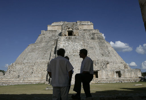 President George W. Bush is silhouetted as he pauses with President Felipe Calderon of Mexico and an interpreter during their tour Tuesday, March 13, 2007, of the Mayan ruins of Uxmal. White House photo by Eric Draper