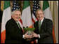 President George W. Bush is presented with a bowl of shamrocks by Ireland's Prime Minister Bertie Ahern at a ceremony in the Roosevelt Room at the White House, March 16, 2007. White House photo by Joyce Boghosian