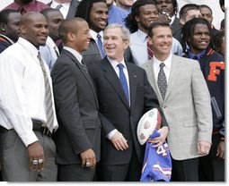 President George W. Bush is joined by University of Florida Gators football coach Urban Meyers, right, and team quarterback Chris Leak during ceremonies at the White House, Monday, March 19, 2007, to honor the 2006 NCAA football championship team. White House photo by Eric Draper