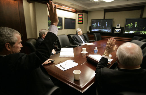 President George W. Bush and Vice President Dick Cheney wave from the Situation Room of the White House Monday, March 19, 2007, as they're joined in a video teleconference by Prime Minister Nouri al-Maliki of Iraq. White House photo by Eric Draper