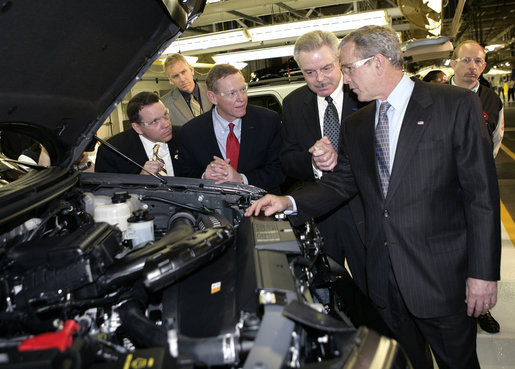 President George W. Bush takes a look under a hood during his tour Tuesday, March 20, 2007, of the Ford Motor Company - Kansas City Assembly Plant in Claycomo, Missouri, joined by, from left, U.S. Rep. Sam Graves, Ford President and CEO Alan Mulally and Ford Group Vice President Derrick Kuzak. White House photo by Eric Draper