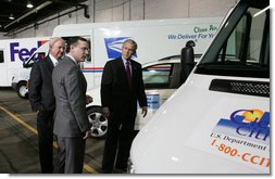 President George W. Bush and Secretary of Energy Sam Bodman listen to Mark Chernoby as the Vice President of Advance Vehicle Engineering at DaimlerChrysler describes the FedEx Pilot Program Plug-in Hybrid Sprinter during the President's visit Tuesday, March 27, 2007, to the U.S. Postal Service Vehicle Maintenance Facility in Washington, D.C. White House photo by Joyce N. Boghosian