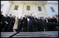 President George W. Bush is surrounded by members of the House Republican Conference on the steps of the North Portico Thursday, March 29, 2007, as he delivers a statement on the budget and the emergency supplemental after meeting with the group. Said the President, "We stand united in saying loud and clear that when we've got a troop in harm's way, we expect that troop to be fully funded; and we've got commanders making tough decisions on the ground, we expect there to be no strings on our commanders; and that we expect the Congress to be wise about how they spend the people's money." White House photo by Eric Draper