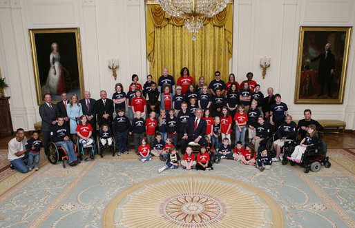 President George W. Bush poses with the Children’s Miracle Network Champions and leadership members in the East Room of the White House, Thursday, March 29, 2007, honoring the CMN organization for their work in helping save and improve the lives of children with severe medical challenges. White House photo by Eric Draper