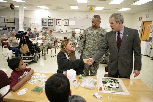 President George W. Bush meets with the family of Sgt. William Enriquez Santos of Carolina, Puerto Rico, Friday, March 30, 2007, during a visit to Walter Reed Army Medical Center in Washington, D.C. Pictured from left are Sgt. Santos’ sons, Josh, 8 and John, 17, and his wife Betsy Rodriguez. White House photo by Eric Draper