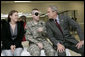 President George W. Bush talks with U.S. Army Sgt. Joel Robert Kalka and his girlfriend and caregiver, Amanda Sue Sink, both of Wailiku, Maui, Hawaii, Friday, March 30, 2007, during a visit to Walter Reed Army Medical Center in Washington, D.C. White House photo by Eric Draper