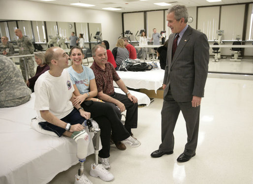 President George W. Bush spends time with Minnesota National Guard Sgt. John Matthew Kriesel of Cottage Grove, Minn., Friday, March 30, 2007, during a visit to Walter Reed Army Medical Center in Washington, D.C. Sitting with Sgt. Kriesel is his wife, Katharine Marie Kriesel, and father John Joseph Kriesel. White House photo by Eric Draper