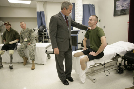 President George W. Bush talks with U.S. Marine Corps Bradley Jerome Walker of White Pine, Tenn., Friday, March 30, 2007, during a visit to Walter Reed Army Medical Center in Washington, D.C. White House photo by Eric Draper