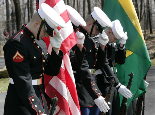 Members of the military honor guard at Camp David bow their heads and hold their hats at the helicopter arrival of Brazilian President Luiz Inacio Lula da Silva, who arrived for a meeting with President George W. Bush, Saturday, March 31, 2007, at the Presidential retreat in Maryland. White House photo by Eric Draper