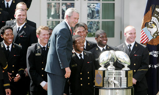 President George W. Bush poses for a photo with members of the U. S. Naval Academy football team and the Commander-In-Chief trophy he presented to the team in ceremonies in the Rose Garden at the White House, Monday, April 2, 2007. White House photo by Joyce Boghosian