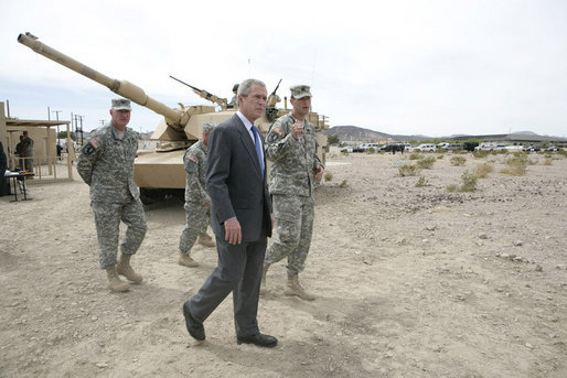 President George W. Bush talks with U.S. Army Captain Pat Armstrong during his visit to the U.S. Army National Training Center Wednesday, April 4, 2007, at Fort Irwin, Calif. White House photo by Eric Draper
