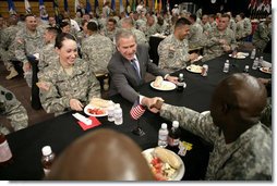 President George W. Bush greets military personnel during lunch at Fort Irwin, Calif., where President Bush addressed the troops and their family members at the U.S.Army’s National Training Center. White House photo by Eric Draper