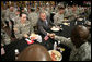 President George W. Bush greets military personnel during lunch at Fort Irwin, Calif., where President Bush addressed the troops and their family members at the U.S. Army’s National Training Center. White House photo by Eric Draper