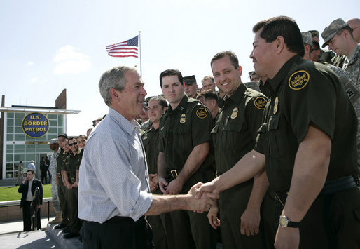 President George W. Bush shakes hands with agents after speaking Monday, April 9, 2007, at the new Yuma Border Patrol Station on comprehensive immigration reform. Speaking in the Arizona border city, the President told his audience, "We've got to resolve the status of millions of illegal immigrants already here in the country. So we're working closely with Republicans and Democrats to find a practical answer that lies between granting automatic citizenship to every illegal immigrant and deporting every illegal immigrant." White House photo by Eric Draper