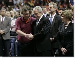 President George W. Bush comforts James Tyger, outgoing Student Government president, Tuesday, April 17, 2007, during the Convocation on the campus of Virginia Tech in Blacksburg, Va. The President and Mrs. Laura Bush attended the service honoring students, faculty and staff who died or were injured in Monday's tragic shooting. White House photo by Eric Draper