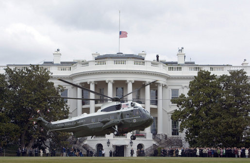 As the American flag flies at half staff in memory of the 33 who died Monday at Virginia Tech, Marine One, with President George W. Bush and Mrs. Laura Bush aboard, lifts off the South Lawn Tuesday, April 17, 2007, en route to Andrews Air Force Base. The President and Mrs. Bush were headed to Blacksburg, Va., home of Virginia Tech, and the Convocation scheduled in the wake of Monday's tragedy. White House photo by Joyce Boghosian