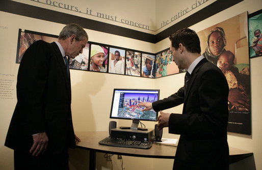 President George W. Bush watches a demonstration of Google Earth by Larry Swaider, Chief Information Officer for the U.S. Holocaust Memorial Museum, during his visit Wednesday, April 18, 2007. The President visited two exhibits and delivered remarks commemorating the Holocaust Days of Remembrance. White House photo by Eric Draper
