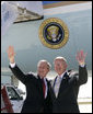 President George W. Bush and Chuck Hinken, of Grand Rapids, Mich., wave after Mr. Hinken was presented the Presidential Volunteer Service Award during the President's visit to Grand Rapids, Mich. Friday, April 20, 2007. The President's Volunteer Service Award recognizes individuals, families, and groups that have achieved a certain standard measured by the number of volunteer hours served over a 12-month period or cumulative hours earned over the course of a lifetime. White House photo by Eric Draper