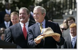 President George W. Bush shows the signed cowboy hat presented to him by Indianapolis Colts team owner and CEO Jim Irsay, left, during the White House ceremony to honor the Super Bowl champions Monday, April 23, 2007. White House photo by Eric Draper