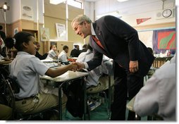 President George W. Bush meets students in the seventh grade science class at Harlem Village Academy Charter School in New York, during his visit to the school Tuesday, April 24, 2007, where President Bush spoke about his "No Child Left Behind" reauthorization proposals.  White House photo by Eric Draper