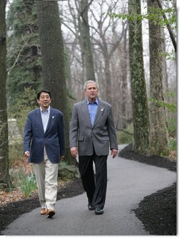 President George W. Bush walks with Prime Minister Shinzo Abe during their meeting Friday, April 27, 2007, at Camp David. Said the President, " We talked about the fact that our alliance -- and it is a global alliance -- is rooted in common values, especially our commitment to freedom and democracy." White House photo by Eric Draper