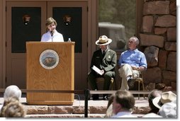 Mrs. Laura Bush speaks to a crowd of about 160 people Sunday, April 29, 2007, during the rededication ceremony of the Zion National Park Nature Center in Springdale, Utah. Interior Secretary Kirk Kempthorne is pictured at the far right. Designed by Gilbert Stanley Underwood in 1934, the center was renovated with new insulation, updated exterior side paneling and restrooms. White House photo by Shealah Craighead