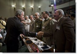 President George W. Bush reaches out to Mr. Shahib Hamad Adnan, Director of Policy and Requirements for the Iraq Defense Department, after delivering remarks Tuesday, May 1, 2007, to the CENTCOM Coalition Conference at MacDill Air Force Base in Tampa. With them are, from left: Mr. Mowaffak Al Rubaie, Iraqi National Security Advisor; Lt. General Yacoob Abdul-rizzaq, Deputy Chief of Staff for Iraq Joint Forces; and Major General Abdul Hasan Mohsen, Director General of Directorate of Border Enforcement.  White House photo by Eric Draper