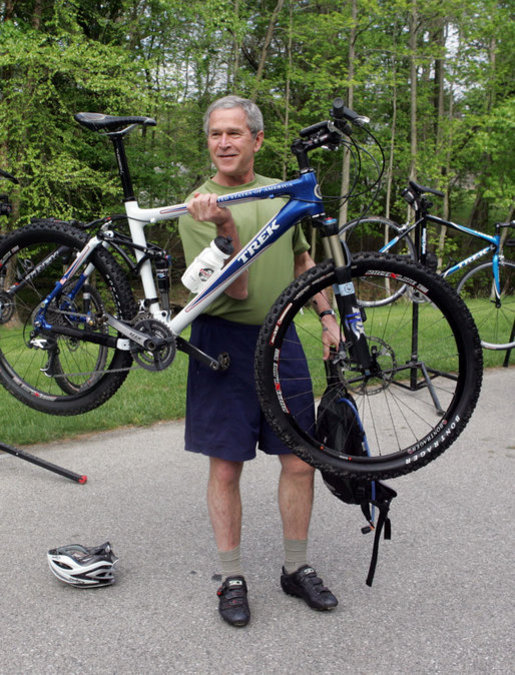 President George W. Bush holds up his mountain bike before riding with members of the President's Council on Physical Fitness and Sports Saturday, May 5, 2007, in Beltsville, Md. "It doesn't take much time to stay fit -- 30 minutes five days a week; 30 minutes of walking, 30 minutes of running, 30 minutes of biking, 30 minutes of swimming on a regular basis will help deal with a lot of health issues here in America," said President Bush, who exercises regularly. White House photo by Joyce Boghosian