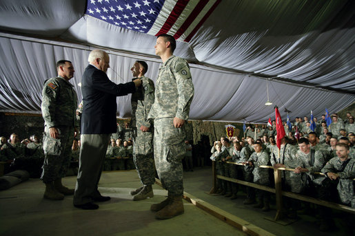 Vice President Dick Cheney awards SSgt Vincent Lewis with the Combat Infantry Badge during a rally for the troops Thursday, May 10, 2007 at Contingency Operating Base Speicher, Iraq. White House photo by David Bohrer