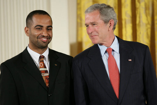 President George W. Bush speaks with award recipient Adeel Khan of Springfield, Va., student body president at Virginia Tech, on stage in the East Room of the White House, where Khan received the President’s Volunteer Service Award Thursday, May 10, 2007, in celebration of Asian Pacific American Heritage Month. White House photo by Eric Draper