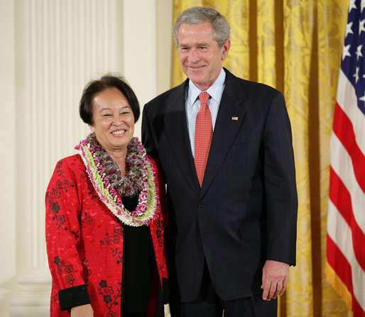 President George W. Bush welcomes Linda Uehara of Mililani, Hawaii, to the stage in the East Room of the White House, to receive the President’s Volunteer Service Award Thursday, May 10, 2007, in celebration of Asian Pacific American Heritage Month. White House photo by Eric Draper