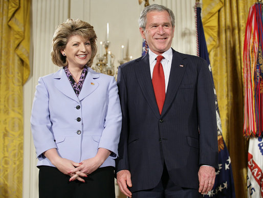 President George W. Bush joins military spouse Denise Rampolla of Cheyenne, Wyo., on stage in the East Room of the White House, to receive the President’s Volunteer Service Award Friday, May 11, 2007, during a commemoration of Military Spouse Day. White House photo by Eric Draper